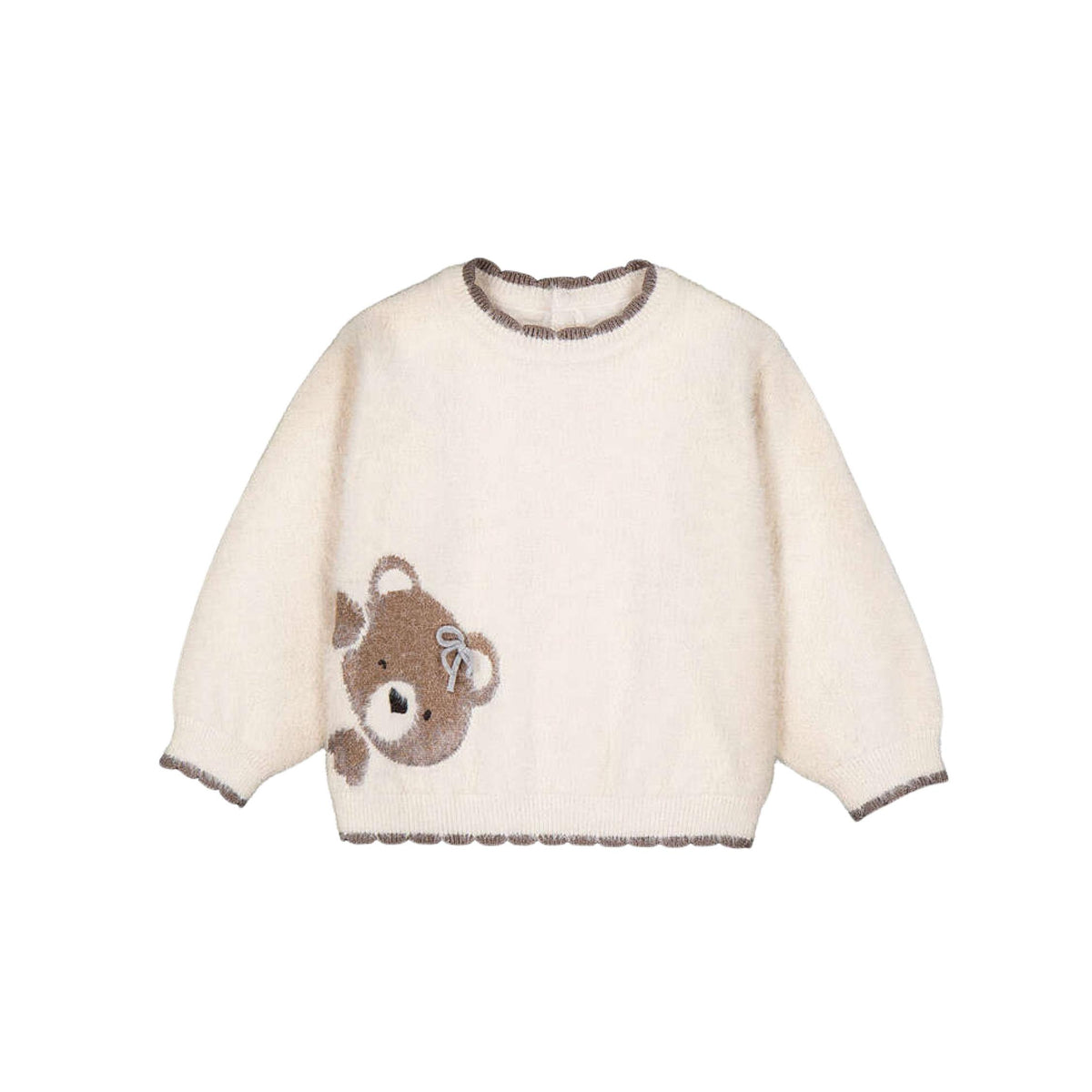 A cream-colored fuzzy knit sweater with a brown teddy bear appliqué on the front right featuring a scalloped trim on the collar, cuffs, and hem.
