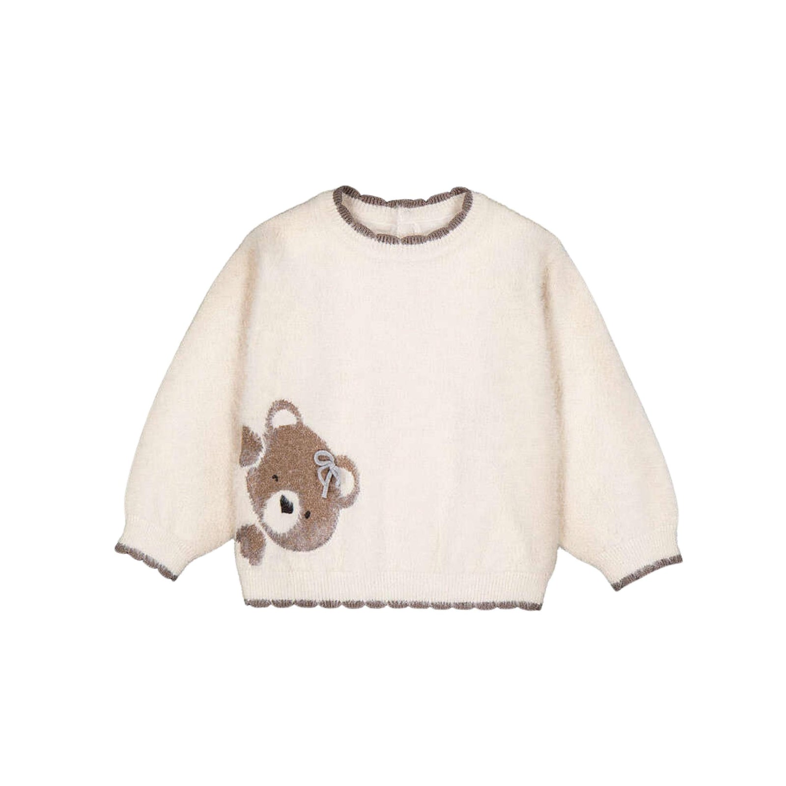 A cream-colored fuzzy knit sweater with a brown teddy bear appliqué on the front right featuring a scalloped trim on the collar, cuffs, and hem.